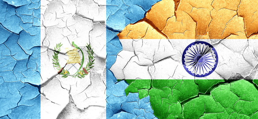 guatemala flag with India flag on a grunge cracked wall