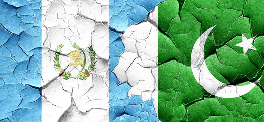 guatemala flag with Pakistan flag on a grunge cracked wall
