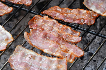 Crispy smoked bacon slices cooked on bbq grill