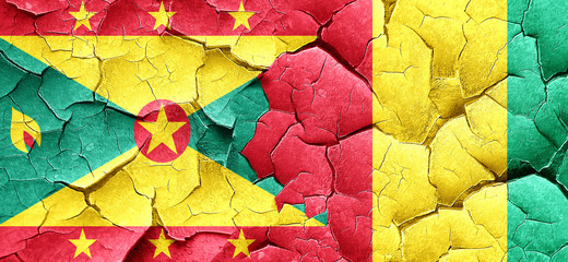 Grenada flag with Guinea flag on a grunge cracked wall