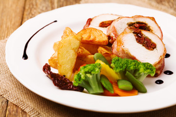 Delicious chicken rolls with dried tomatoes and mozzarella.