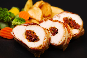 Delicious chicken rolls with dried tomatoes and mozzarella.