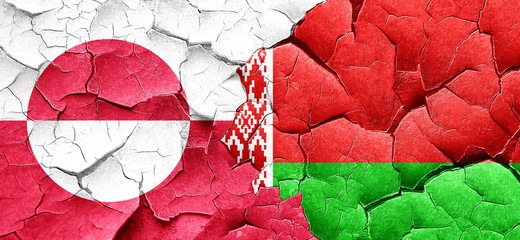 greenland flag with Belarus flag on a grunge cracked wall