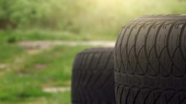 Close up of obsolete used car tires with blur traffic in background