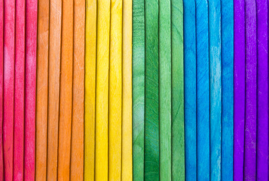 Abstract gay pride rainbow spectrum background on textured layered wood