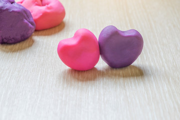 pieces of plasticine on wooden background.