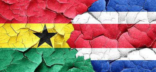 Ghana flag with Costa Rica flag on a grunge cracked wall