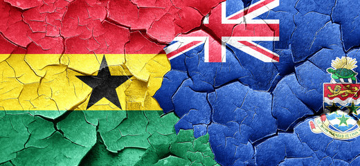 Ghana flag with Cayman islands flag on a grunge cracked wall