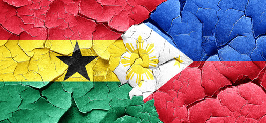 Ghana flag with Philippines flag on a grunge cracked wall