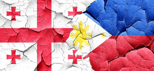 Georgia flag with Philippines flag on a grunge cracked wall