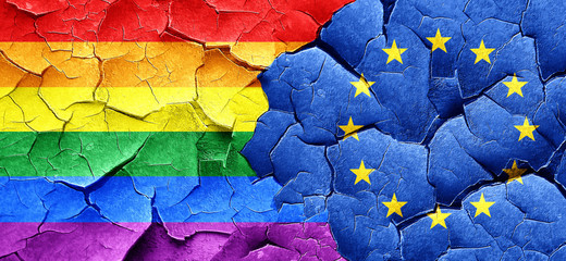 Gay pride flag with european union flag on a grunge cracked wall