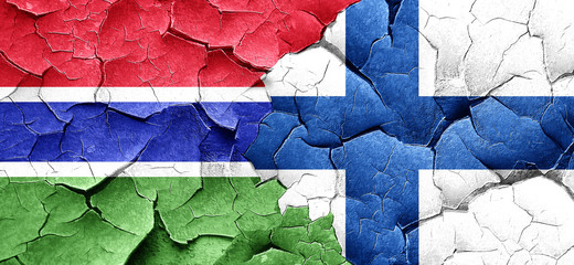 Gambia flag with Finland flag on a grunge cracked wall