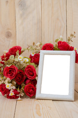 Old wooden picture frame with clipping path and red flowers