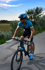 Fototapeta na wymiar cyclist going mountain bike along a lonely road