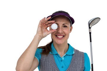 Golf player posing with a golf club and golf ball