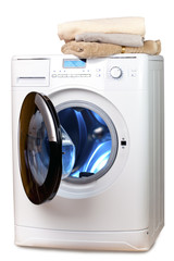The washing machine with an open door and linen