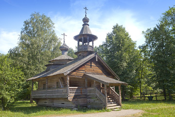 Ancient wooden church on a forest glade. Russia...