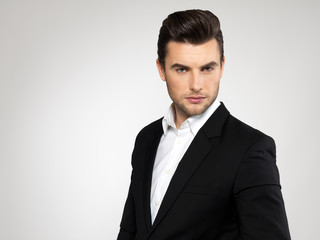 Fashion young businessman in black suit