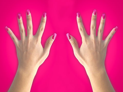 woman hand with pink nail on pink background