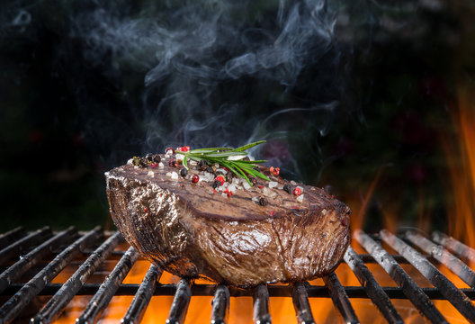 Grilled beef steak on the grill.