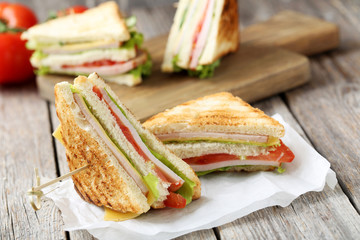 Tasty and fresh sandwiches on a grey wooden table