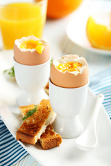 Boiled egg with toasts on a blue wooden table