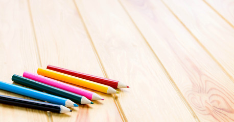 Fototapeta premium color pencils on brown wooden table
