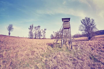 Photo sur Aluminium Chasser Vintage toned fisheye lens photo of a hunting pulpit on a field, Poland.