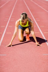 Female athlete ready to run on running track