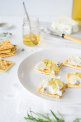 Crackers with gorgonzola and herb and white sweet wine  jelly. Selective focus