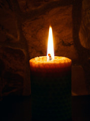 Candle on dark background.