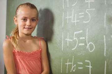 Girl standing in front of blackboard