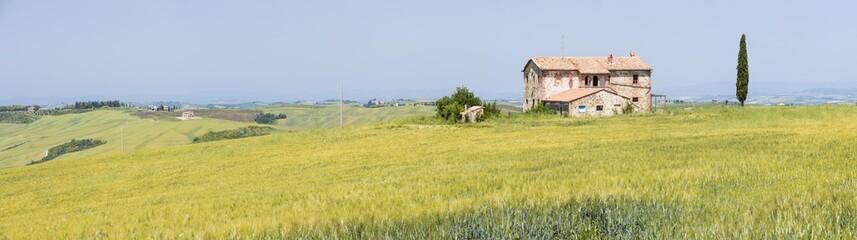 Fototapeta na wymiar panorama with old farm in sunny day in Tuscany in Italy