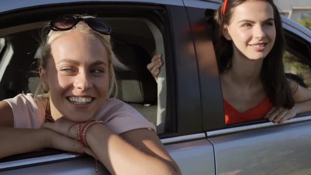 happy teenage girls or women in car at seaside 68