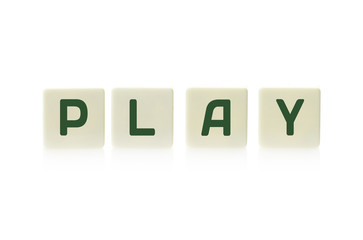 Word "Play" on board game square plastic tile pieces, isolated on a white background.