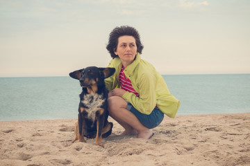Dreaming woman sits with a dog