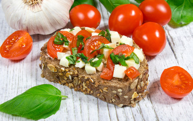 Ciabatta bread with tomatoes, mozzarella and basil.