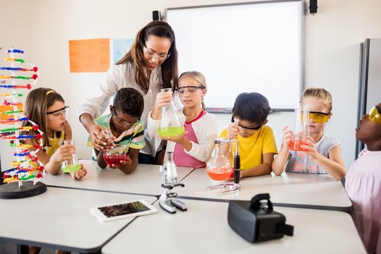 Pupils doing science with a teacher