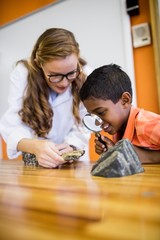 Children looking fossils with a magnifying glass © WavebreakMediaMicro