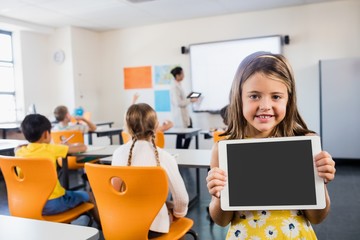 Child posing with a tablet