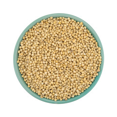 Whole grain sorghum seeds in a bowl isolated on white background top view.