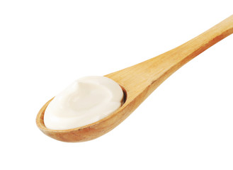 White cream on a wooden spoon
