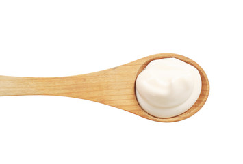 White cream on a wooden spoon
