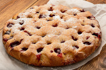 Delicious strawberry pie on wooden background.