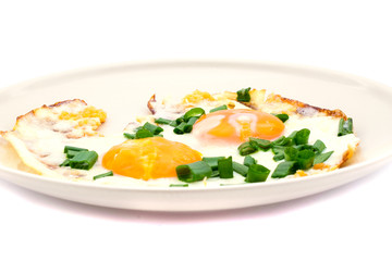 Two fried eggs with chives for healthy breakfast.