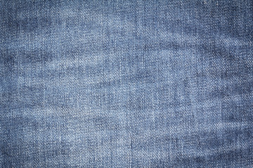 Closeup denim jeans texture. Stitched textured blue denim jeans background. Old grunge vintage denim jeans. Denim jeans fashion design. Dark edged.