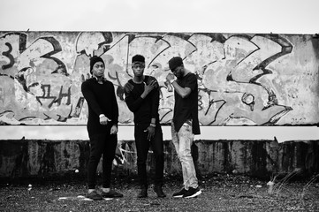 Three rap singers band on the roof background graffiti wall