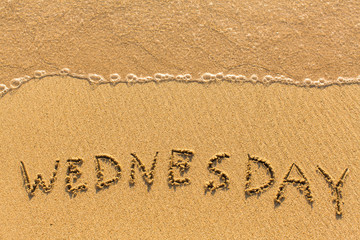 Wednesday - drawn on the sand beach with the soft wave.