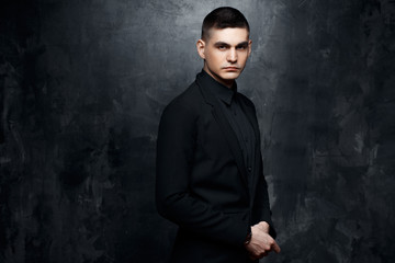 Portrait of handsome man in a black suit.