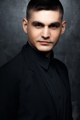 Fototapeta premium Portrait of handsome man in a black suit.